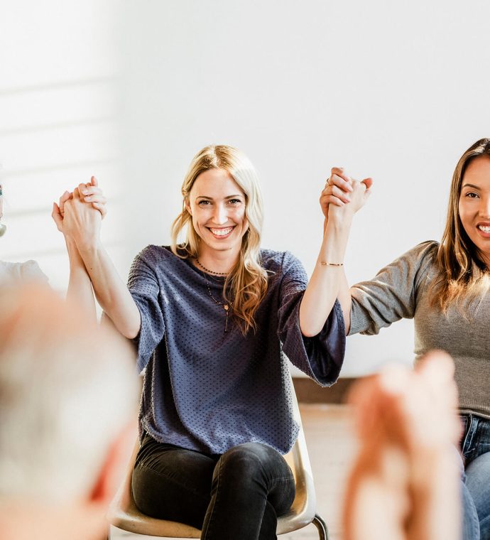 group-of-diverse-people-holding-hands-up-in-the-ai-MAJ7XT5-1.jpg